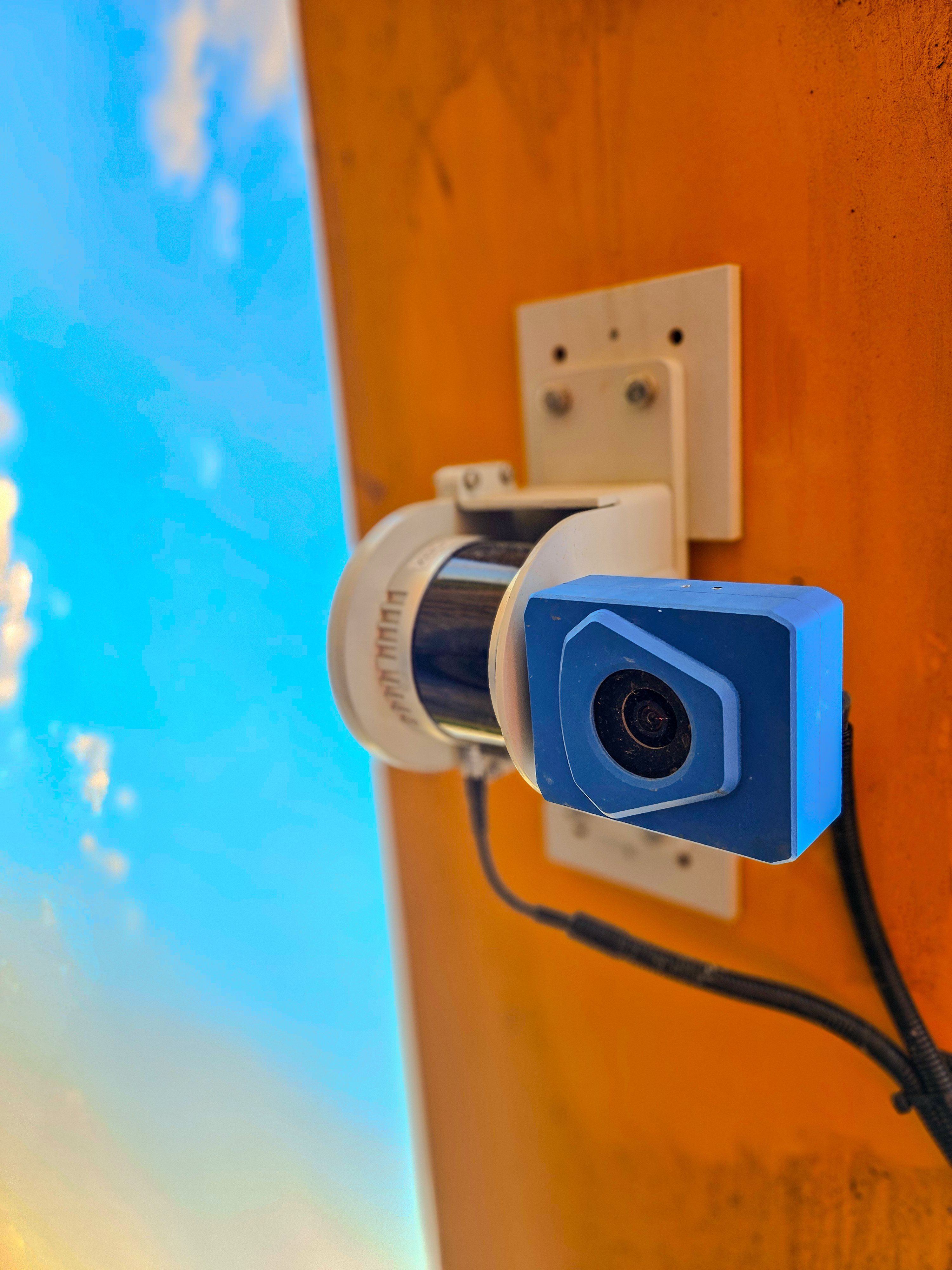 SDX-4DVision LiDAR scanner with a blue camera housing, mounted on the side of an orange machine arm